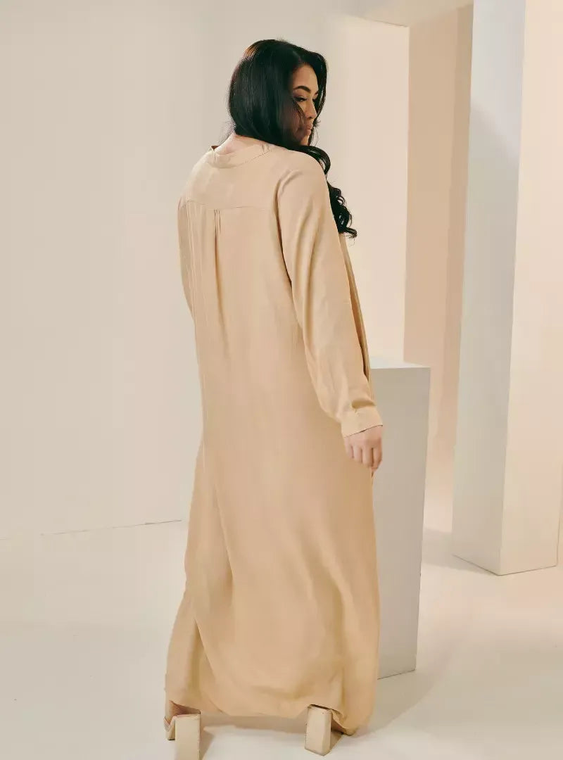 A woman dressed in Sand Selsae Mandarin Collar Kaftan