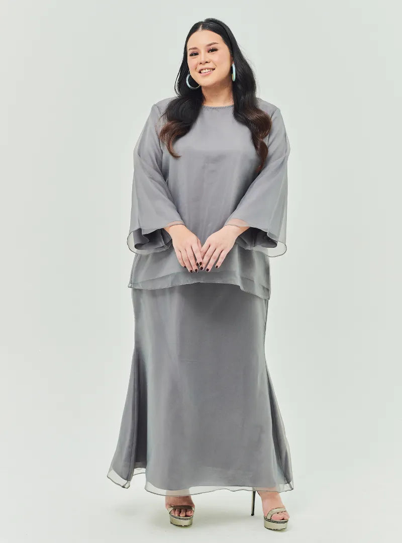 A woman dressed in Silver Grey Tun Aminah Organza Basic Kurung