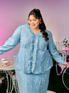  A woman dressed in Stone Blue Tun Anisah Kebaya Kurung