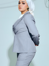 A woman wearing in Stone Grey Amber Peplum Blazer