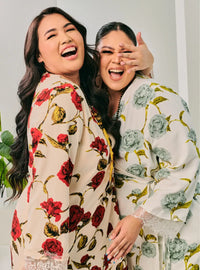 Two women dressed in Grey and Red Tun Bunga Printed Wrap Kurung