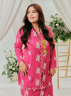 A woman dressed in Pink Doll Tun Saloma Klasik Kebaya Kurung