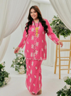 A woman dressed in Pink Doll Tun Saloma Klasik Kebaya Kurung