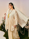 A woman dressed in Sand Champagne Tun Seroja Satin Kurung Pahang