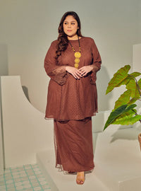 A woman dressed Walnut Tun Melur Dotted Kurung Pahang-