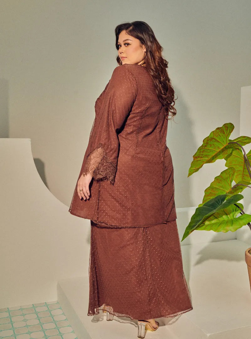 A woman dressed Walnut Tun Melur Dotted Kurung Pahang-