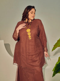 A woman dressed Walnut Tun Melur Dotted Kurung Pahang-