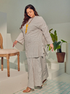 A woman dressed in White Checked Tun Zainab Vintage Checked Kurung