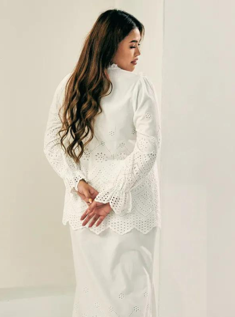 A woman dressed in White Ezzah Eyelet Doll Top