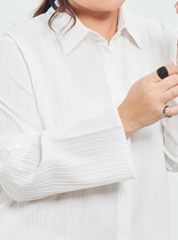 A woman dressed in White Textured Shirt