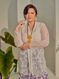 A woman dressed in White Tun Basirah Kebaya Lace Nyonya