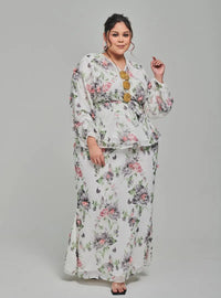 A woman dressed in White Tun Hamidah Chiffon Wrap Kurung