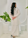 A woman dressed in White Tun Inna Kurung