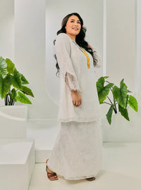 A woman dressed in White Tun Kuntom Cotton Lace Kurung