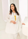 A woman dressed in White Tun Malika Feather Wrap Kurung