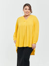 A woman dressed in Yellow Mandarin Collar Oversized Shirt