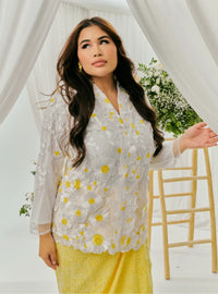 A woman dressed in Yellow Daisy Tun Jaeda Kebaya Nyonya Kurung