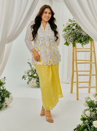 A woman dressed in Yellow Daisy Tun Jaeda Kebaya Nyonya Kurung