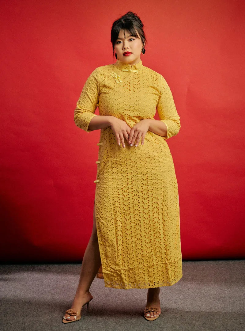 A woman dressed in Yellow Mi Gu Eyelet Cheongsam Dress