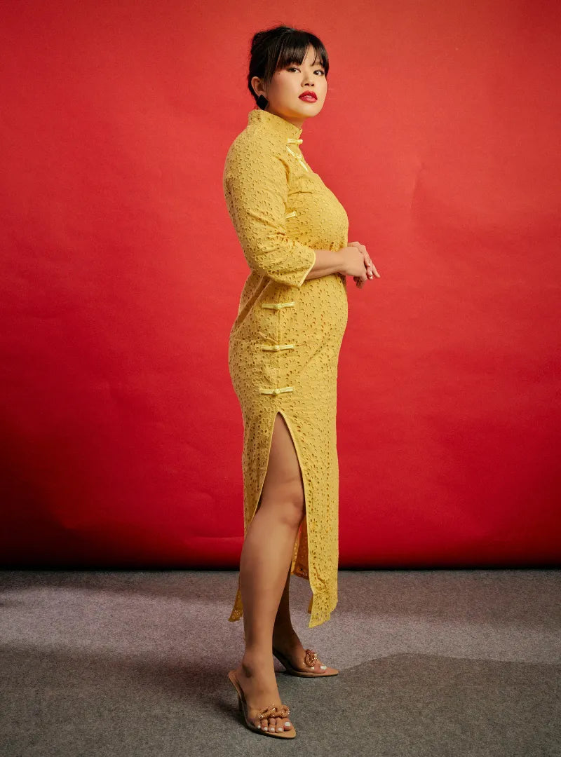 A woman dressed in Yellow Mi Gu Eyelet Cheongsam Dress