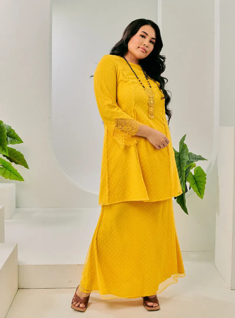 A woman dressed Yellow Tun Melur Dotted Kurung Pahang-