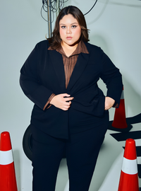 A woman wearing in Black Amber Peplum Blazer - OL Series